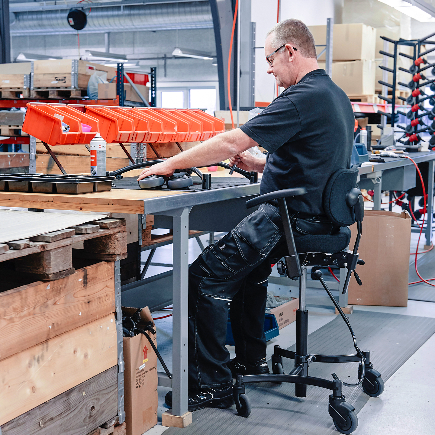 Aufstehhilfe für Behinderte: Mensch mit Behinderung nutzt mobilen Aufstehstuhl